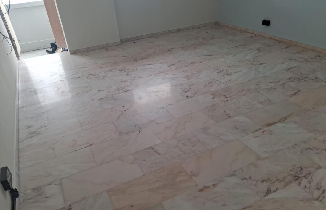Dull pink marble floor before restoration