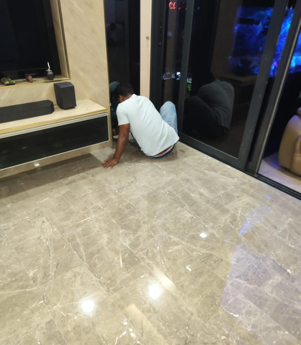 Hand finishing marble edges by a sliding door