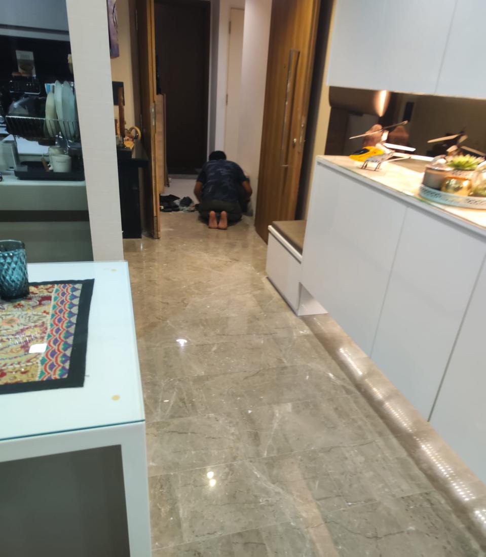 Technician working marble edges next to a kitchen island